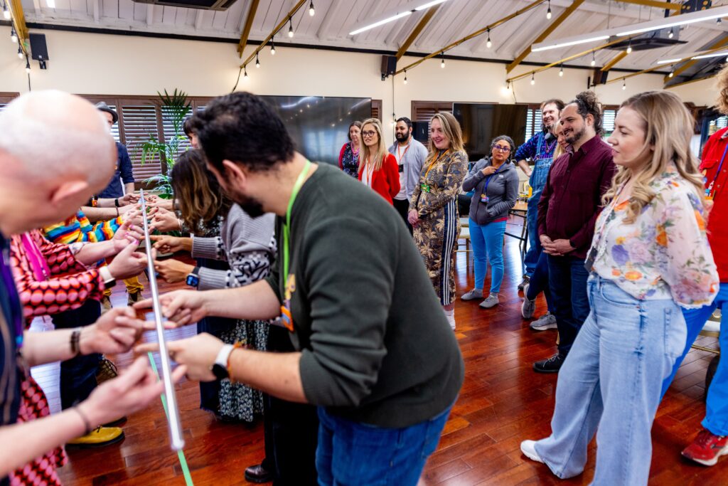 Group of participants at the ITE conference gathered at the Inclusive Facilitation Exchange 2025 conference. Engaging in an interactive ‘ice meters’ activity.